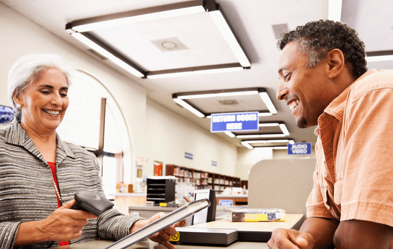 Library worker and patron at a counter