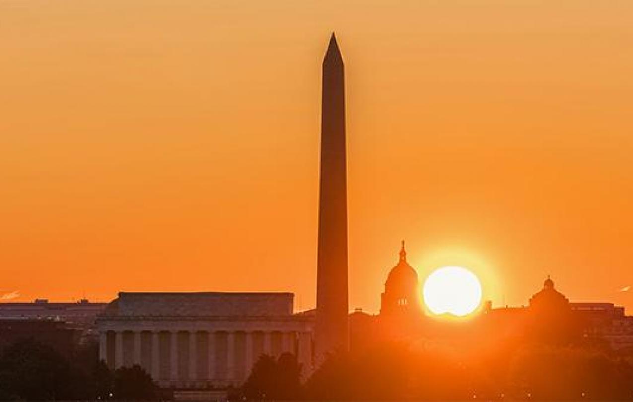 The sun sets over the Washington Memorial in Washington, D.C.